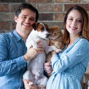 Man holding dog, pregnant woman holding cat