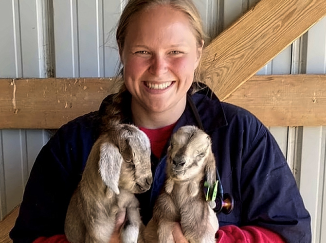 Ellen Dauphinaise holding 2 small goats